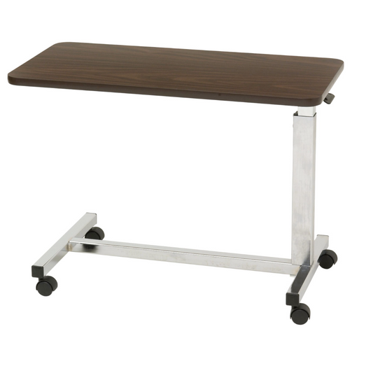 Drive Medical low height overbed table with adjustable surface and sturdy base, designed for convenient bedside use.