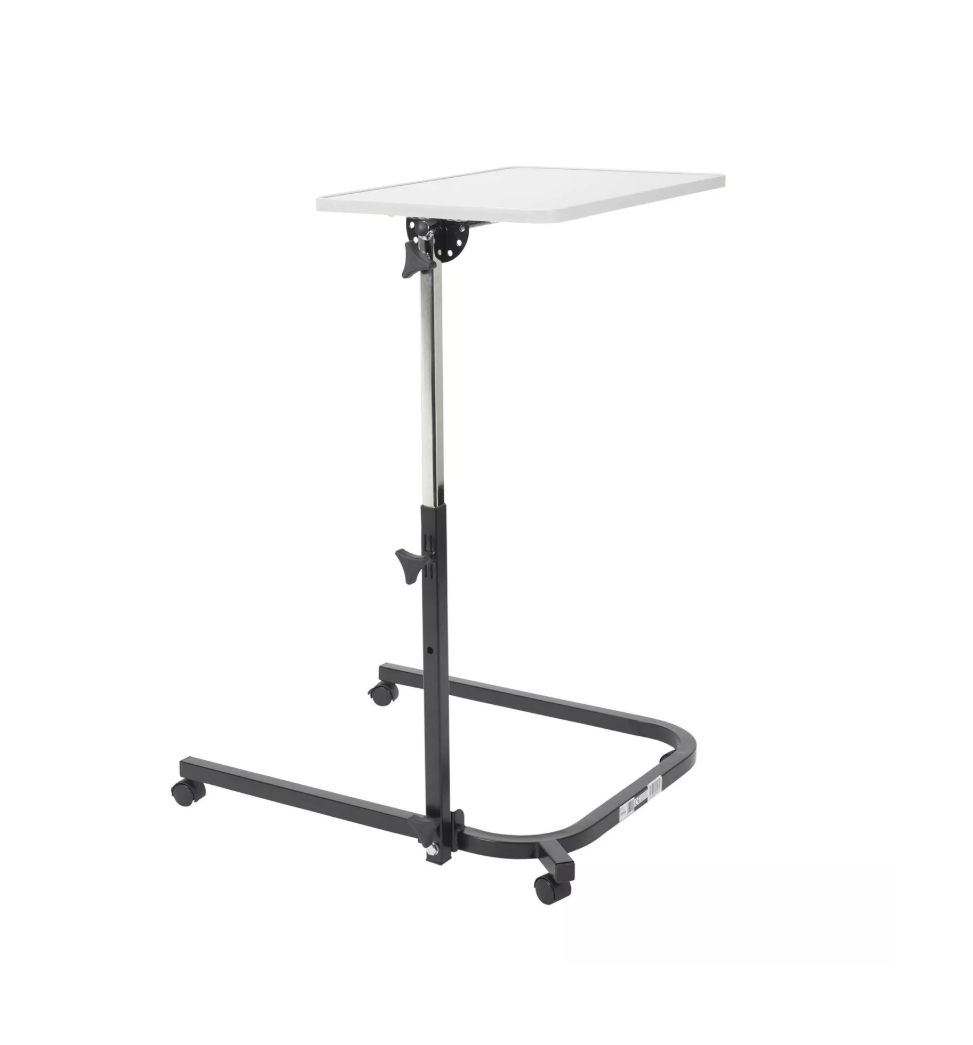 Drive Medical pivot and tilt adjustable overbed table with a wooden surface and metal frame, designed for comfort and convenience.