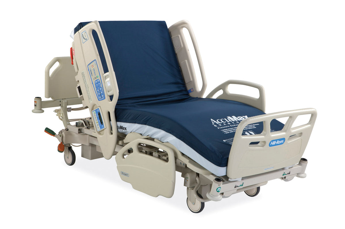 Hill Rom 11170 Care Assist hospital bed with foam mattress, featuring adjustable side rails and control panel for patient comfort.