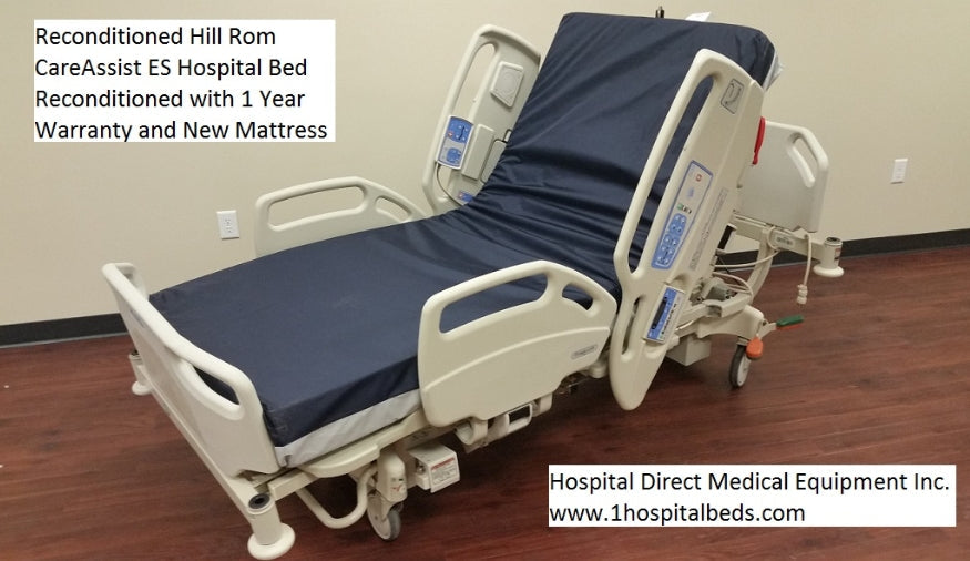 Hill Rom 11170 Care Assist hospital bed with foam mattress, featuring adjustable side rails and a sturdy metal frame.