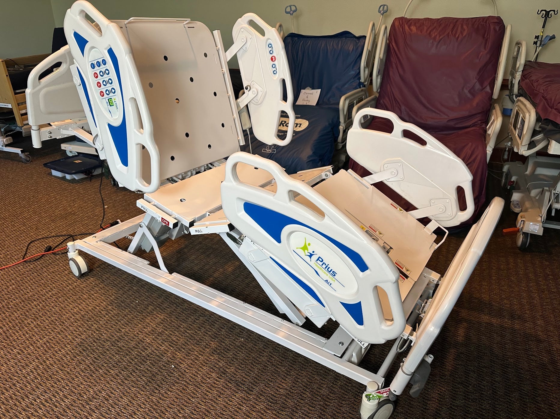 Prius Ai1 bariatric hospital bed with extra-wide high low adjustable frame and side rails for patient comfort and safety.