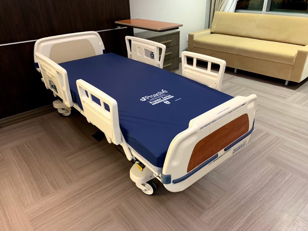 Stryker Secure 2 Model 3002 hospital bed with foam mattress, featuring adjustable side rails and medical-grade design